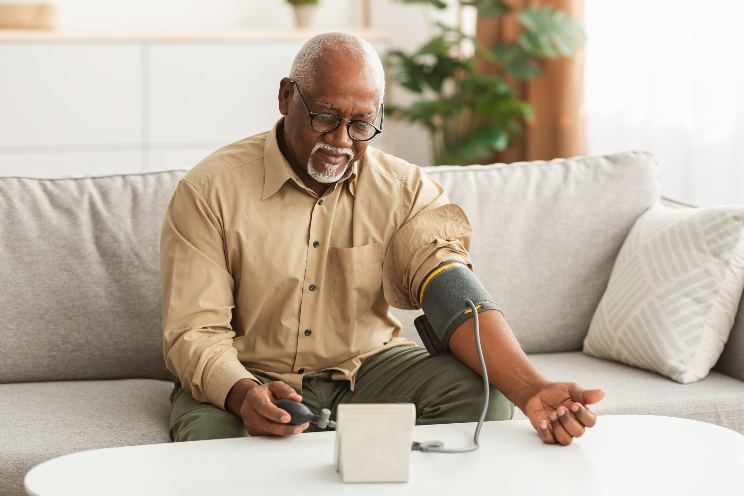 American Man Measuring Arterial Blood Pressure At Home